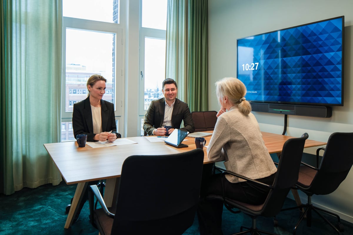 three people in conference room